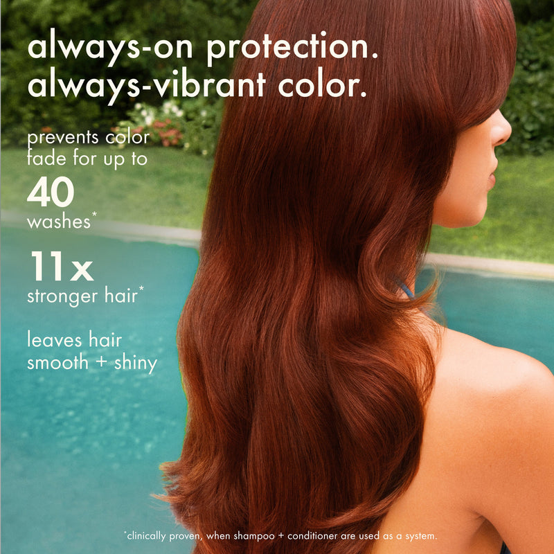 Woman with long reddish-brown hair. Overlaid text reads: "always-on protection. always-vibrant color. Prevents color fade for up to 40 washes. 11x stronger hair. Leaves hair smooth + shiny."