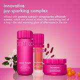 amika's body products appear with jasmine flowers and red berries on a pink surface. text reads “innovative joy-sparking complex” and references jasmine extract and sanguisorba officinalis extract.