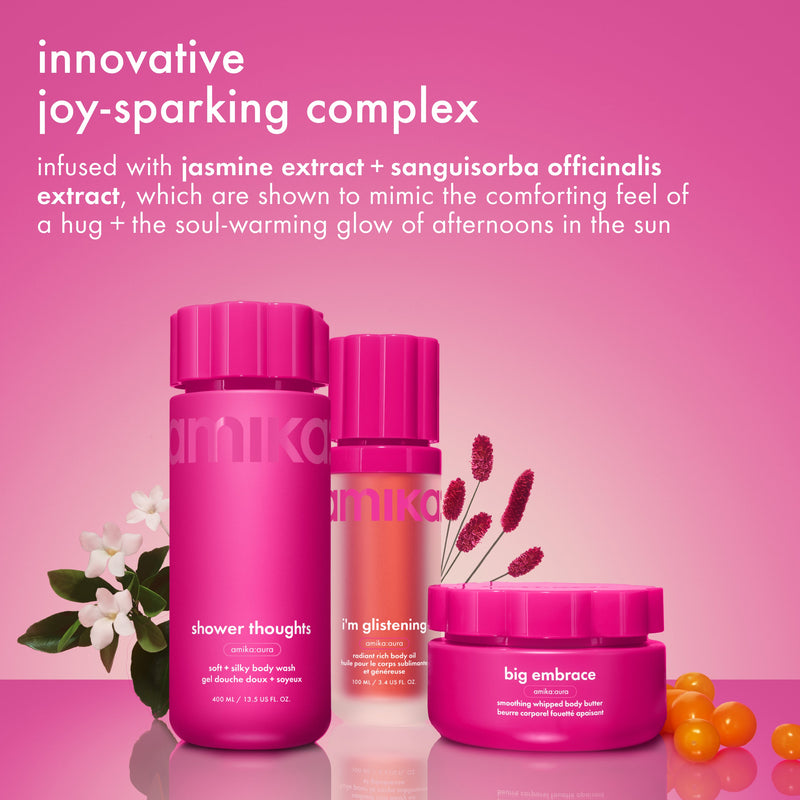 amika's body products appear with jasmine flowers and red berries on a pink surface. text reads “innovative joy-sparking complex” and references jasmine extract and sanguisorba officinalis extract.